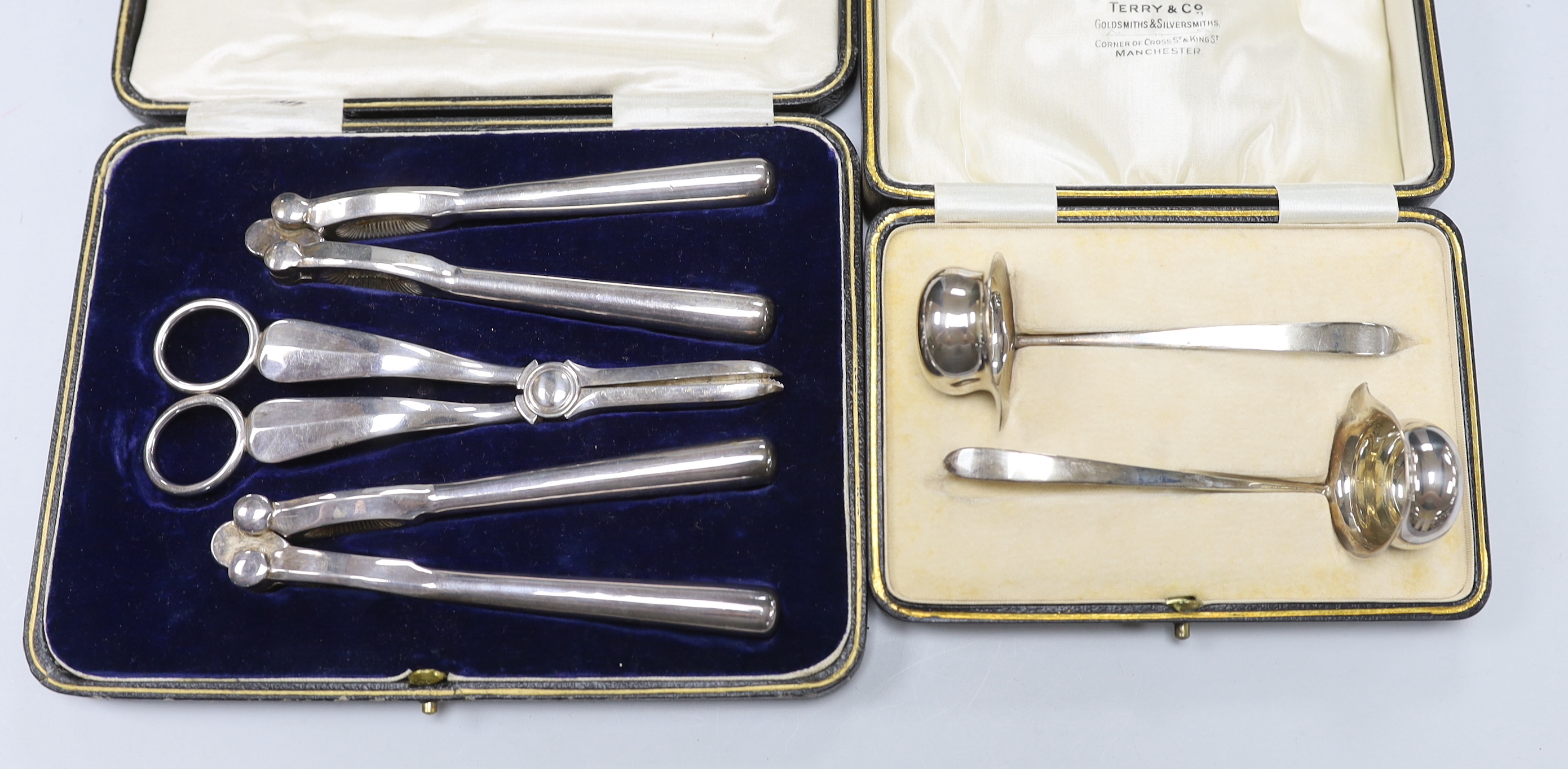 A cased pair of George V silver toddy ladles, Cooper Brothers & Sons, Sheffield, 1926, a silver trinket box and a cased plated grape shears and nutcracker set.
